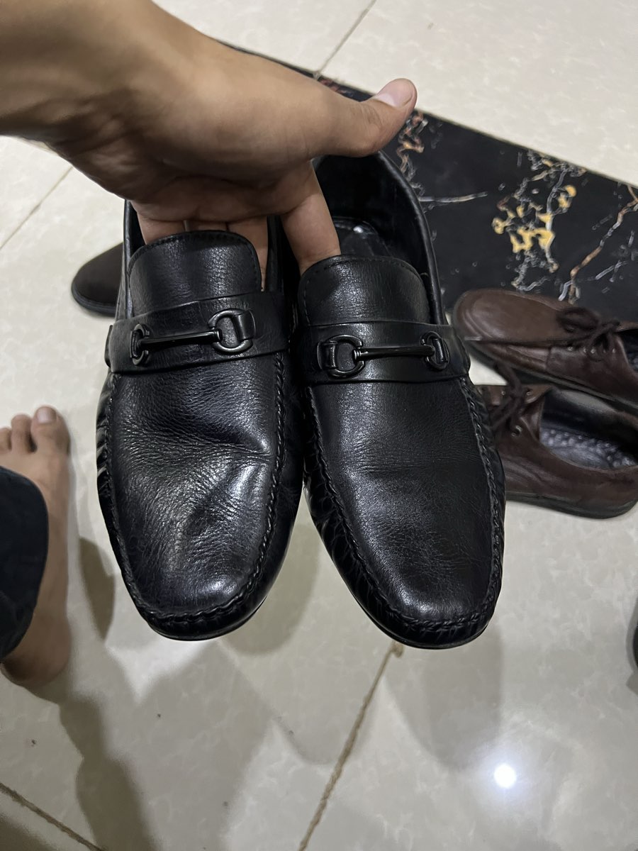 Black leather loafer with metal buckle